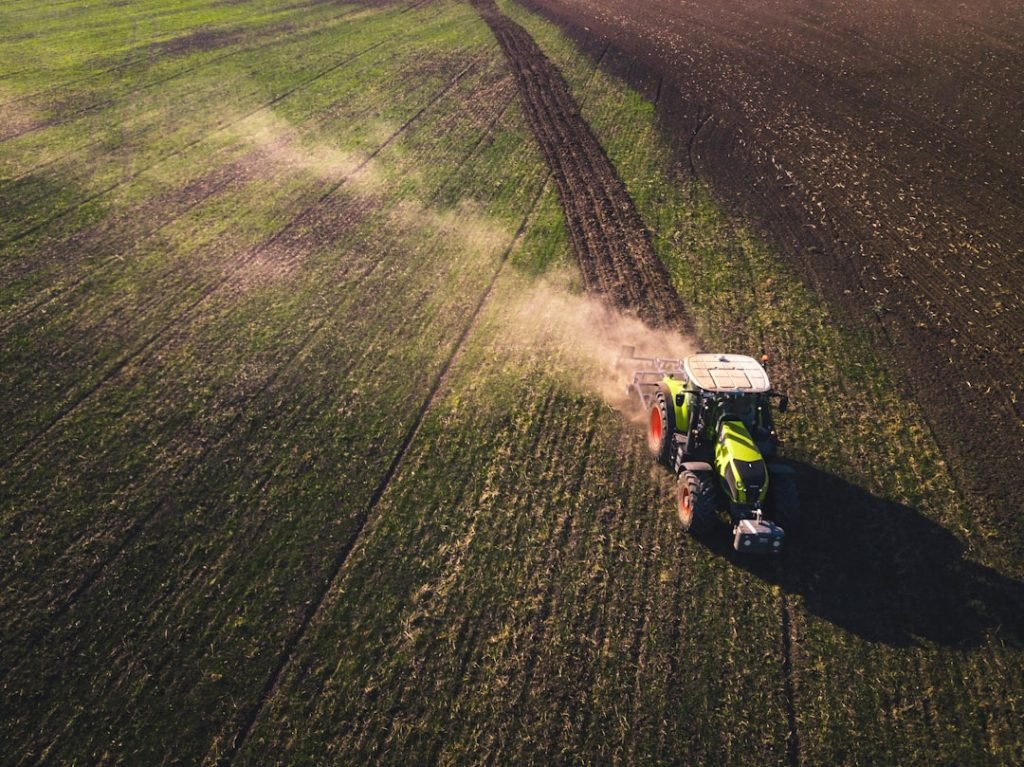 green-and-white-tractor-on-green-grass-field-during-daytime-yjdztdeheg8
